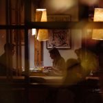 Romantic dining scene in a cozy restaurant with warm lighting and intimate atmosphere.
