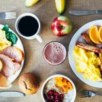 Vibrant breakfast with eggs, fruits, toast, and coffee for a wholesome start.