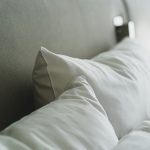A close-up view of cozy white pillows and bedding in a modern bedroom.
