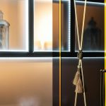 Stylish modern interior featuring a lantern and tassel decor with soft illumination.